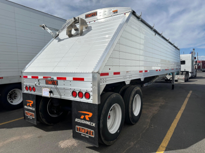 Framed aluminum Timpte frac sand hopper trailer showing rear and side panels with bumper, mud flaps, and dual axles.