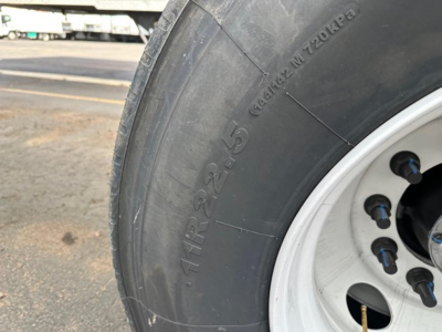 Tire close-up on new 2026 Timpte frac sand hopper trailer showing heavy-duty wheel and tire with rim, no visible damage.