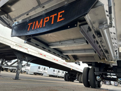 TimptE frac sand hopper trailer underside showing black frame with orange TIMPTE branding.