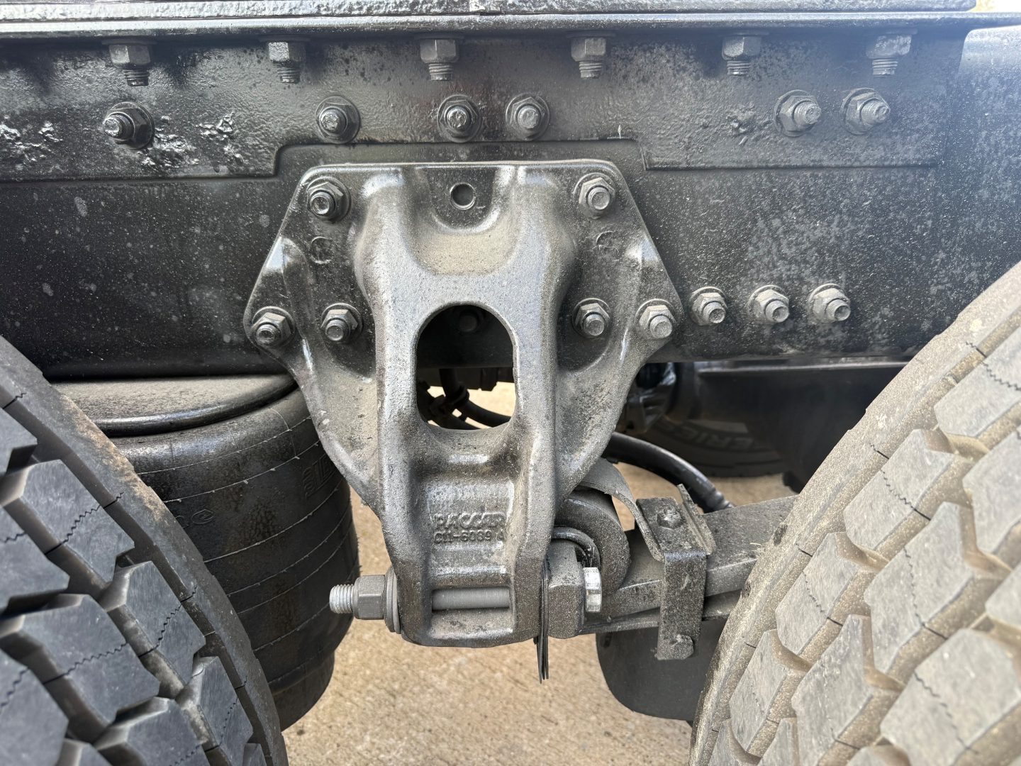 Kenworth T680 chassis with fifth-wheel hitch mounting bracket and dual rear trailer undercarriage bolts visible