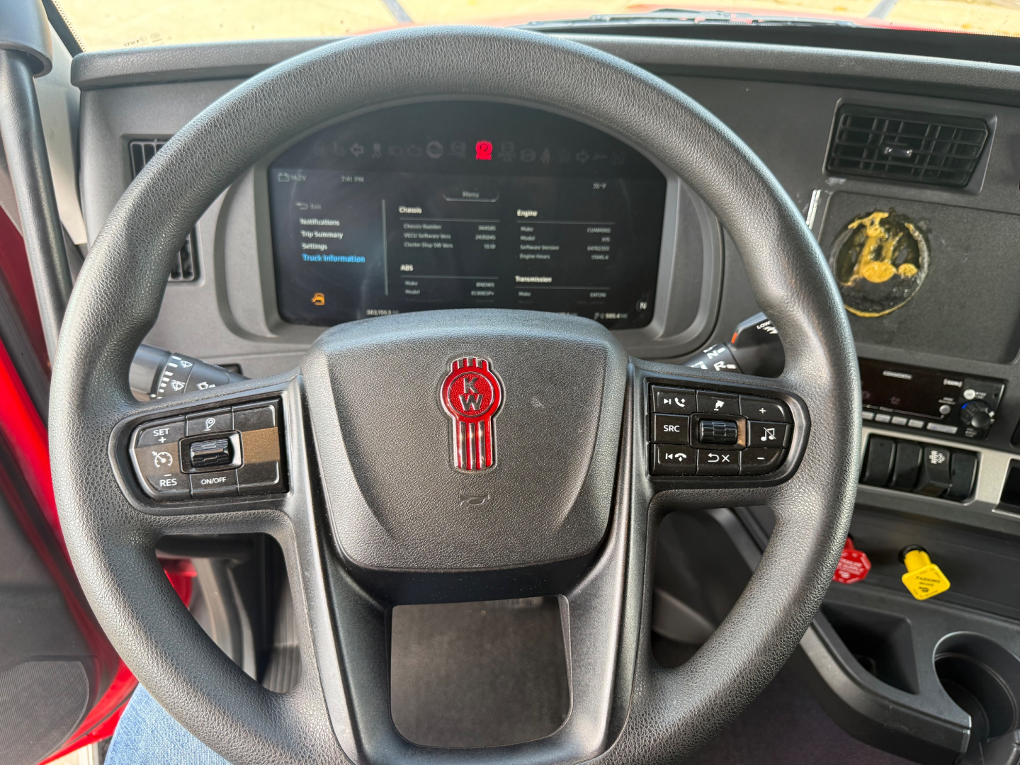 Kenworth T680 dashboard and steering wheel viewed from driver seat showing instrument cluster and controls.