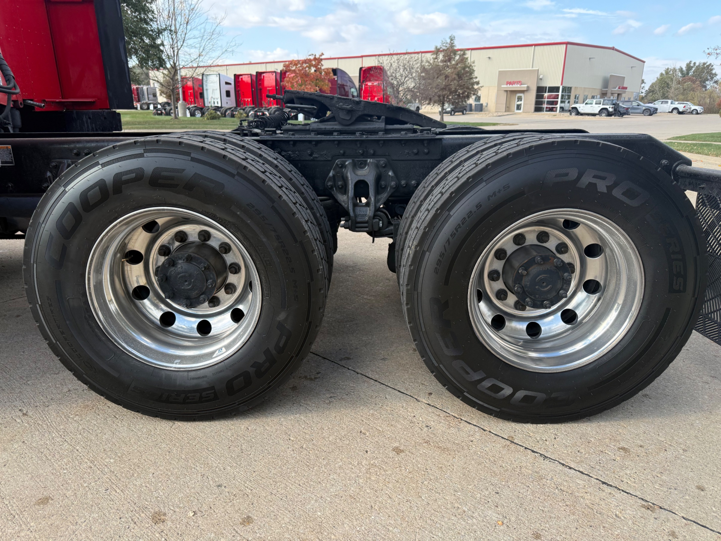 Kenworth T680 chassis dual rear wheels showing 19.5 inch rims and Bridgestone tires with BDR lettering; side of truck with flatbed/tractor frame and suspension components visible.