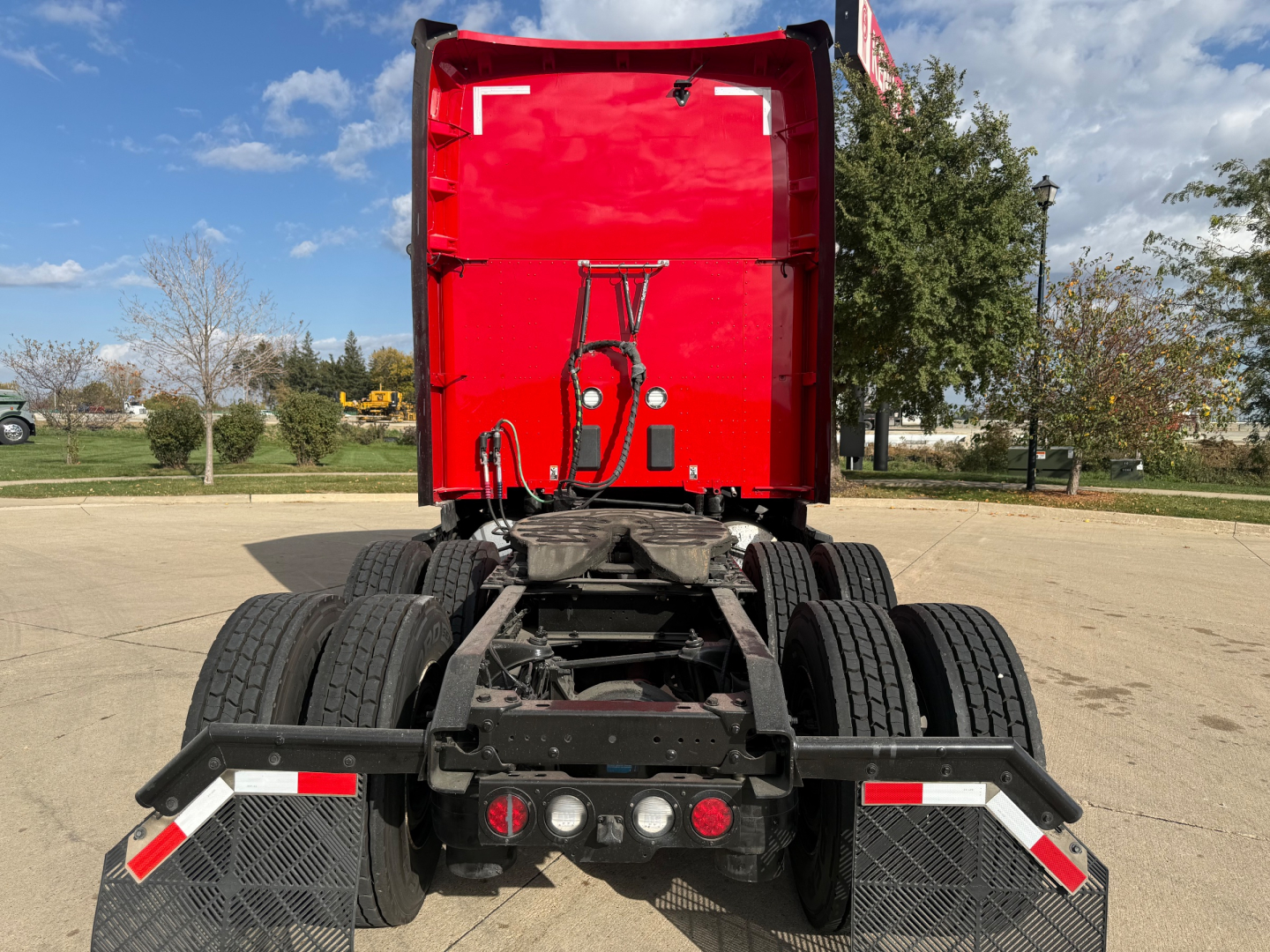Kenworth T680 2024 cab rear view showing fifth wheel, dual rear axles, and back of sleeper with red cab; stock number 0632738 not visible; VIN partially visible.