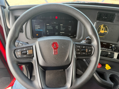 Kenworth T680 dashboard and steering wheel viewed from driver seat showing instrument cluster and controls.