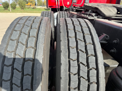 Dual rear truck tires on a Kenworth T680 chassis showing tread pattern and sidewalls.