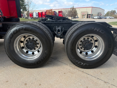 Kenworth T680 chassis dual rear wheels showing 19.5 inch rims and Bridgestone tires with BDR lettering; side of truck with flatbed/tractor frame and suspension components visible.