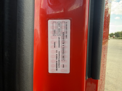 Label on Kenworth T680 door jamb showing model, VIN, and weights in a vertical sticker.