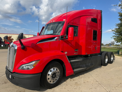 Kenworth T680 truck in red, side view showing cab and rear dual axles.