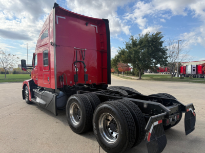 Kenworth T680 truck rear/side showing sleeper cab and dual rear axles with mud flaps.