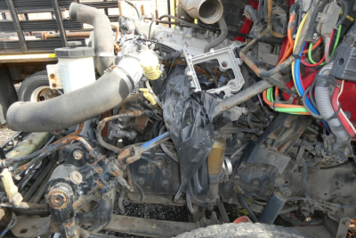 Engine and components with exposed wiring and hoses in a truck engine bay; no legible text clearly visible on components.