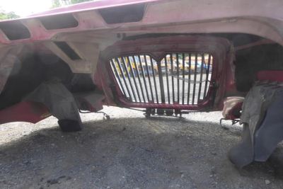 Truck front view showing grille and underside of cab on a 2012 International PROSTAR (conventional daycab) with exposed chassis and wheels.