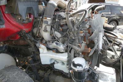Truck engine bay showing international prostar diesel engine with complex wiring and intake manifolds.