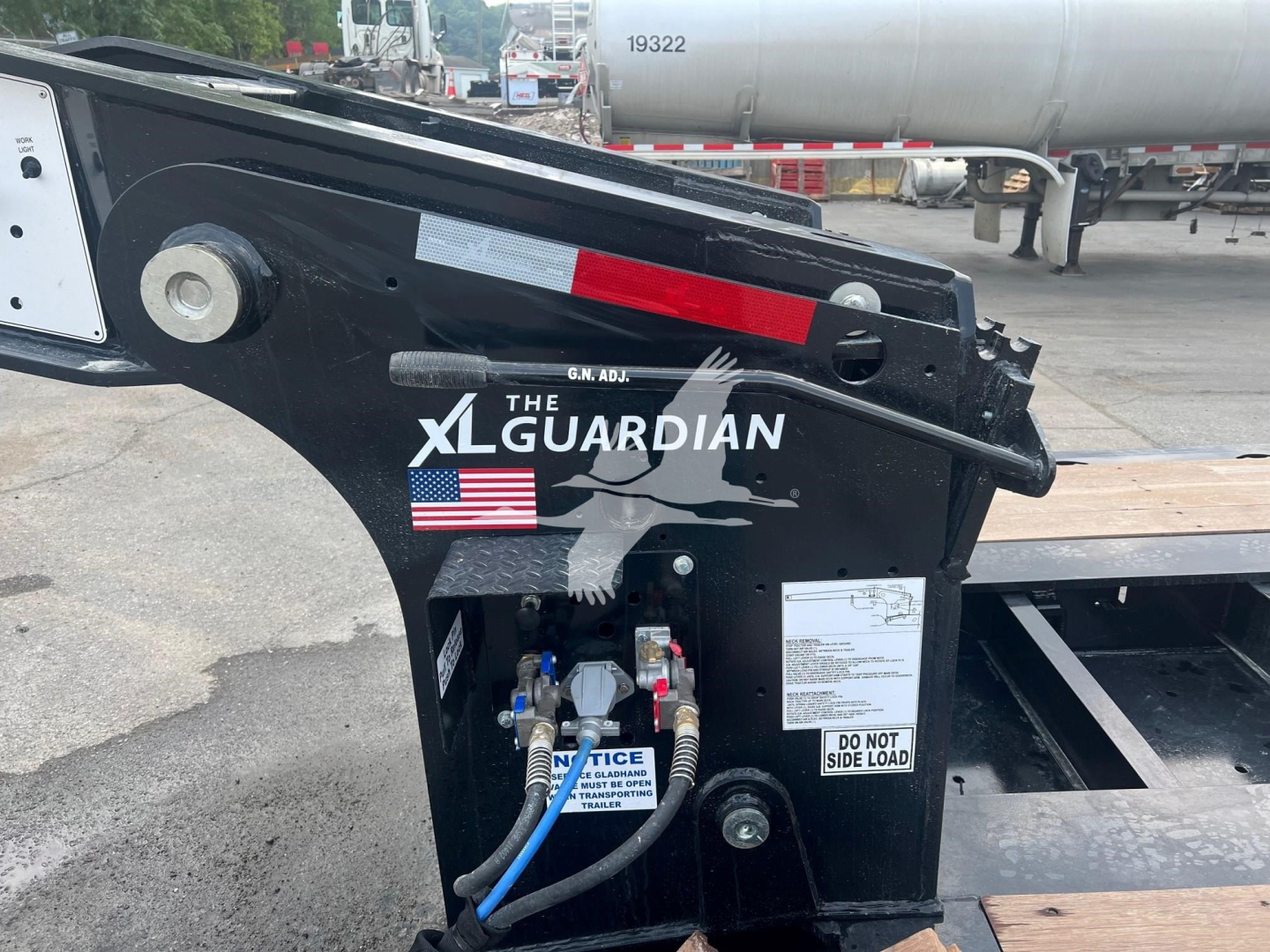XL Guardian XR 110HDGS trailer hitch area showing hydraulic lines and label text. Do not side load sticker visible on frame.