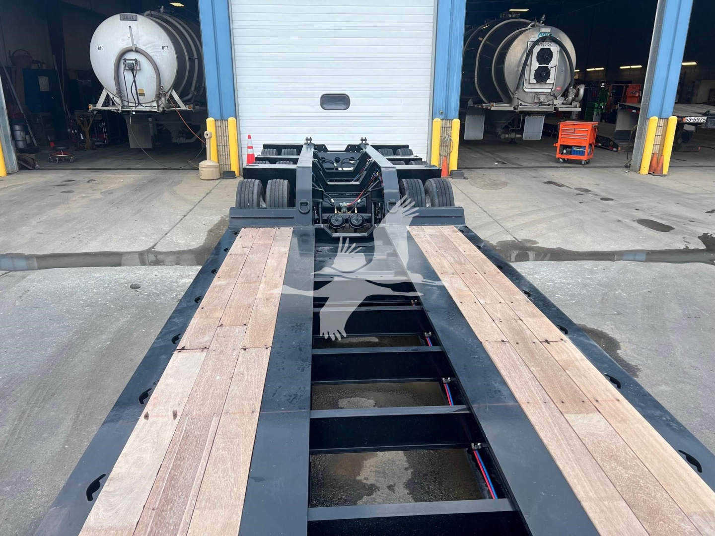 Trailer deck with XL Specialized XL110HDGS lowboy showing wooden deck planks and black steel frame.