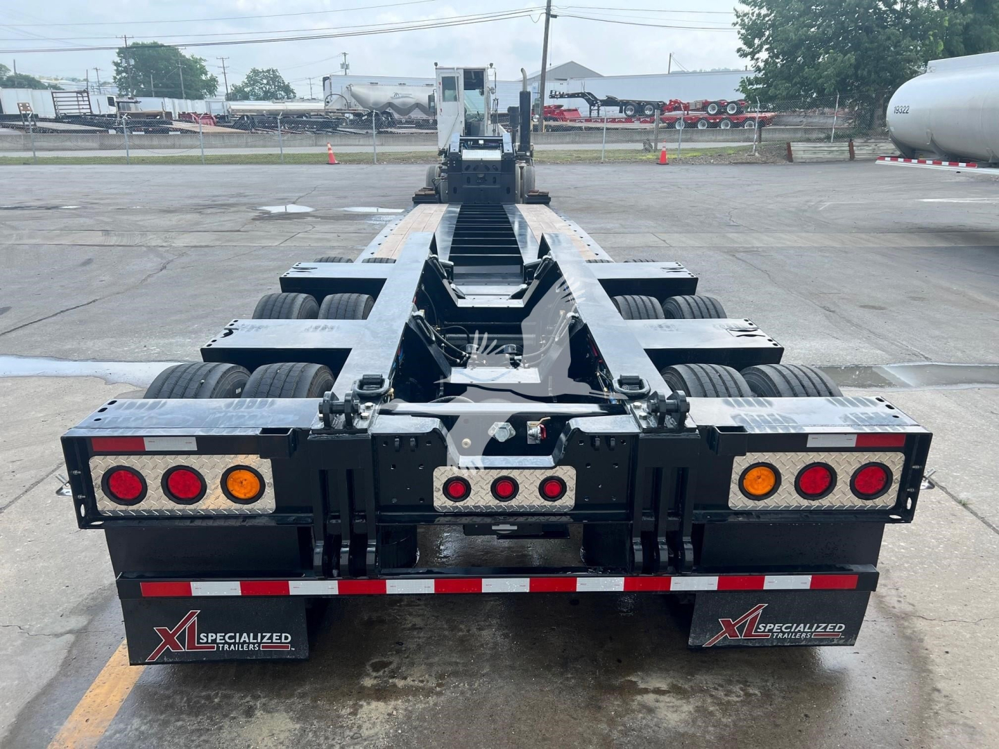 Trailer rear view of XL Specialized XL110HDGS lowboy trailer showing dual axle configuration, taillights, and reflective markers.