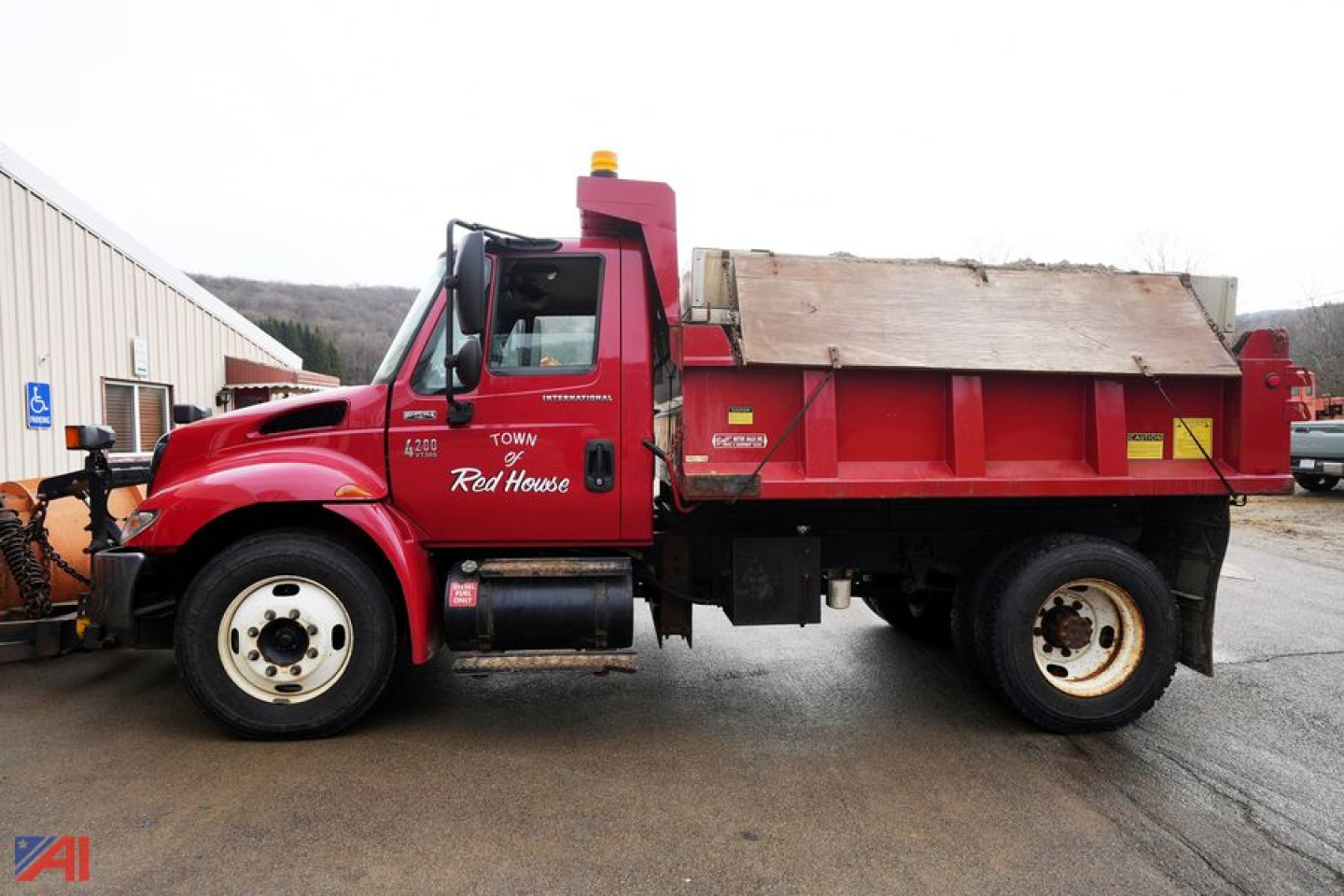 Dump truck with plow and spreader showing Red House markings and 4x4 International 4200 Cab.