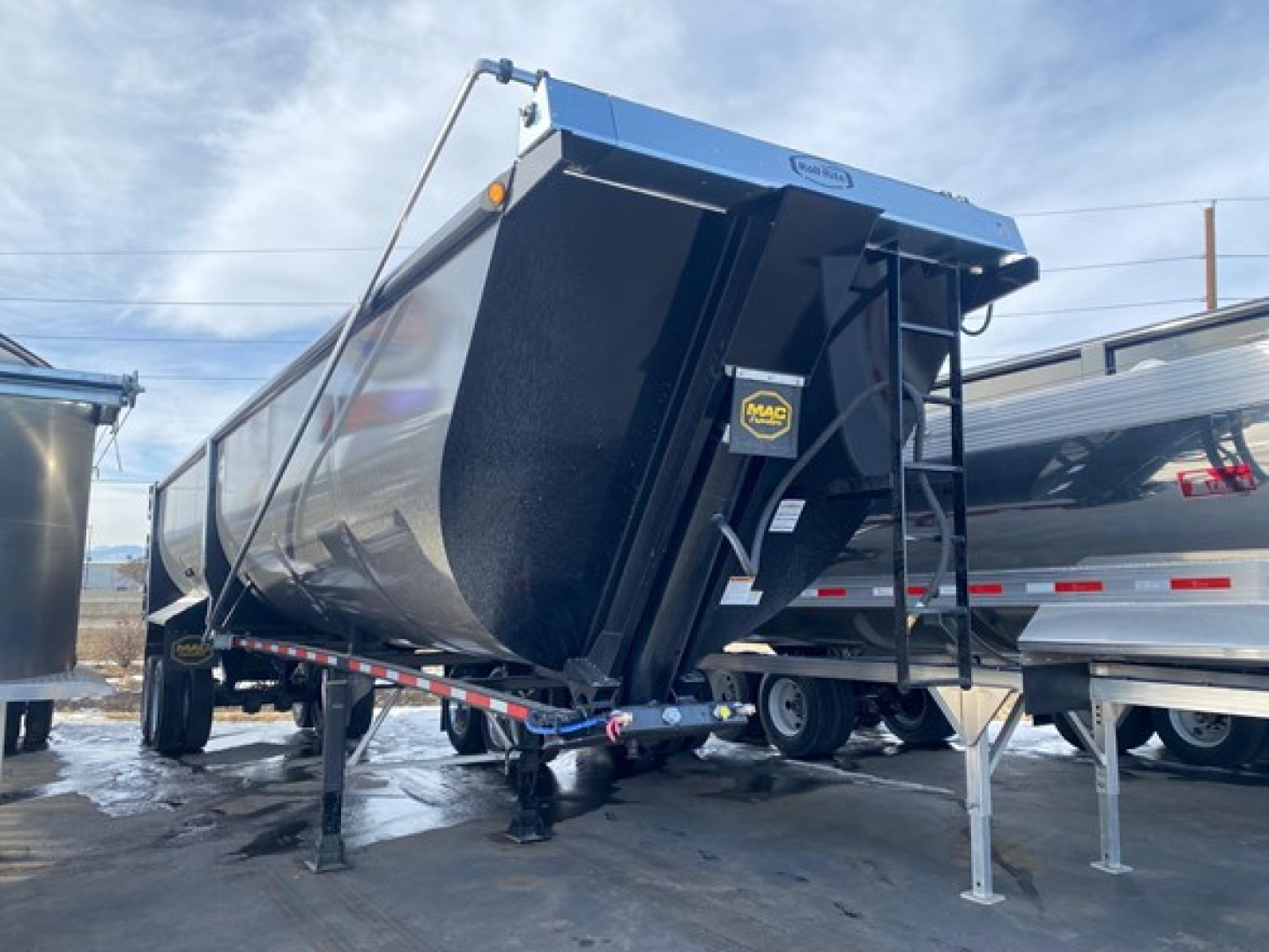 MacDump trailer side scrap trailer in blue/black with side swing tarp and front hitch, 76 inch high cube, new condition text not visible.