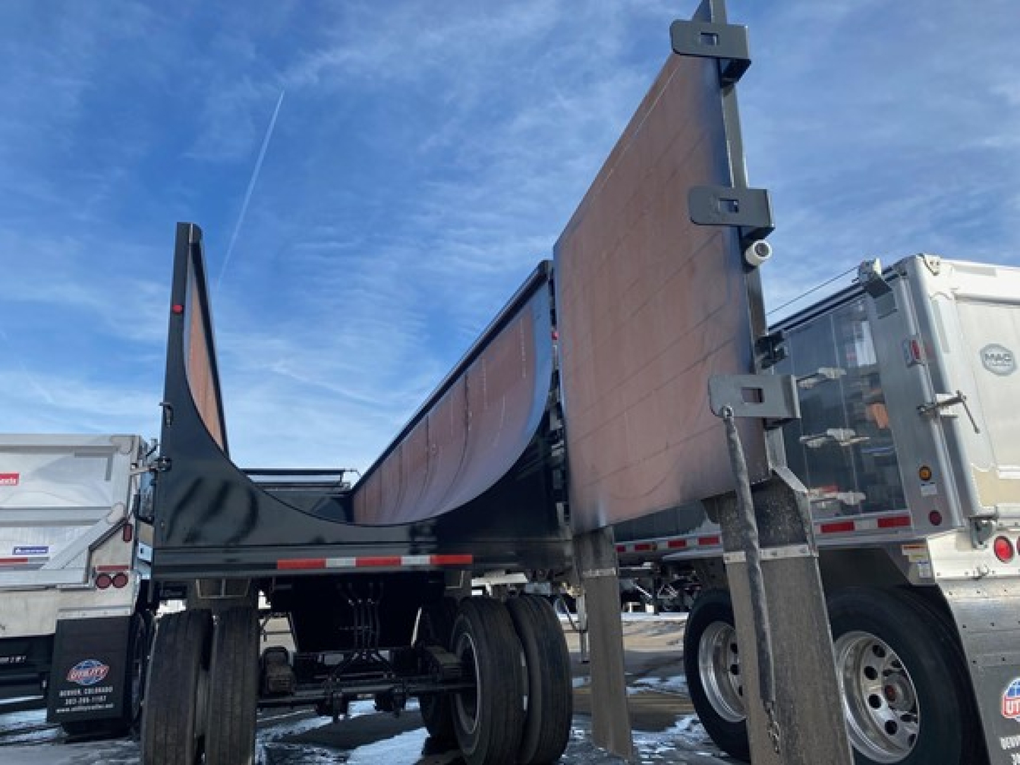 Side scrap trailer with tall sidewalls, 76-inch side height, Mac brand dump trailer in new condition, open-top with side panels raised.