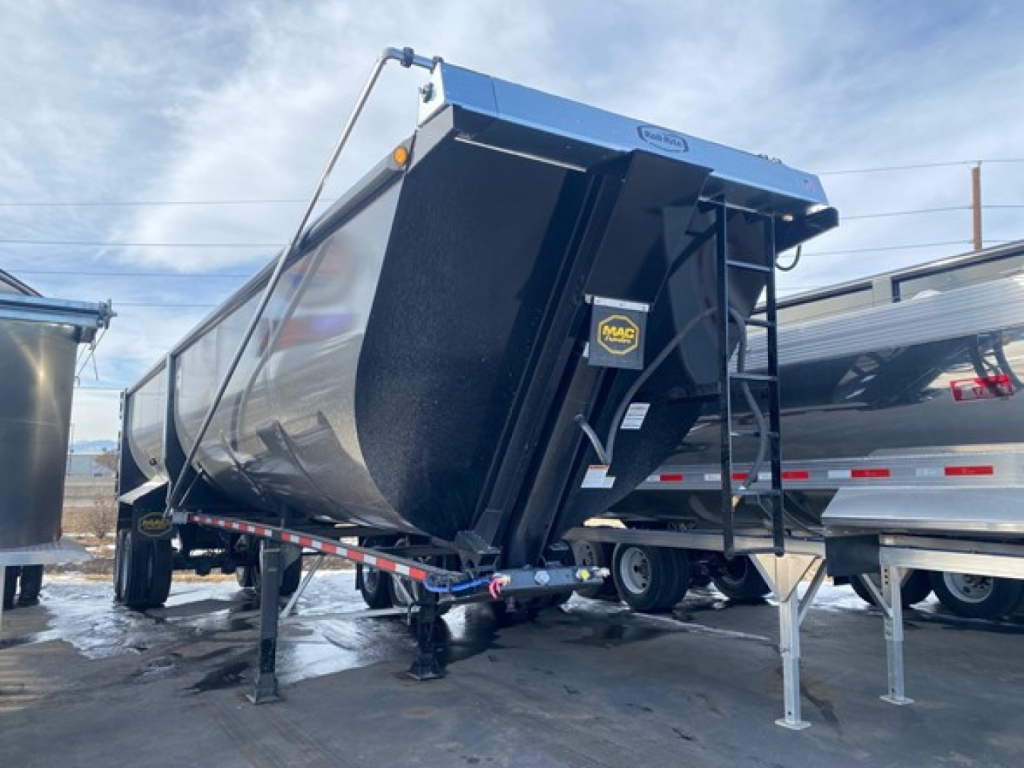 MacDump trailer side scrap trailer in blue/black with side swing tarp and front hitch, 76 inch high cube, new condition text not visible.