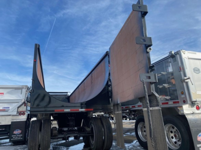 Side scrap trailer with tall sidewalls, 76-inch side height, Mac brand dump trailer in new condition, open-top with side panels raised.