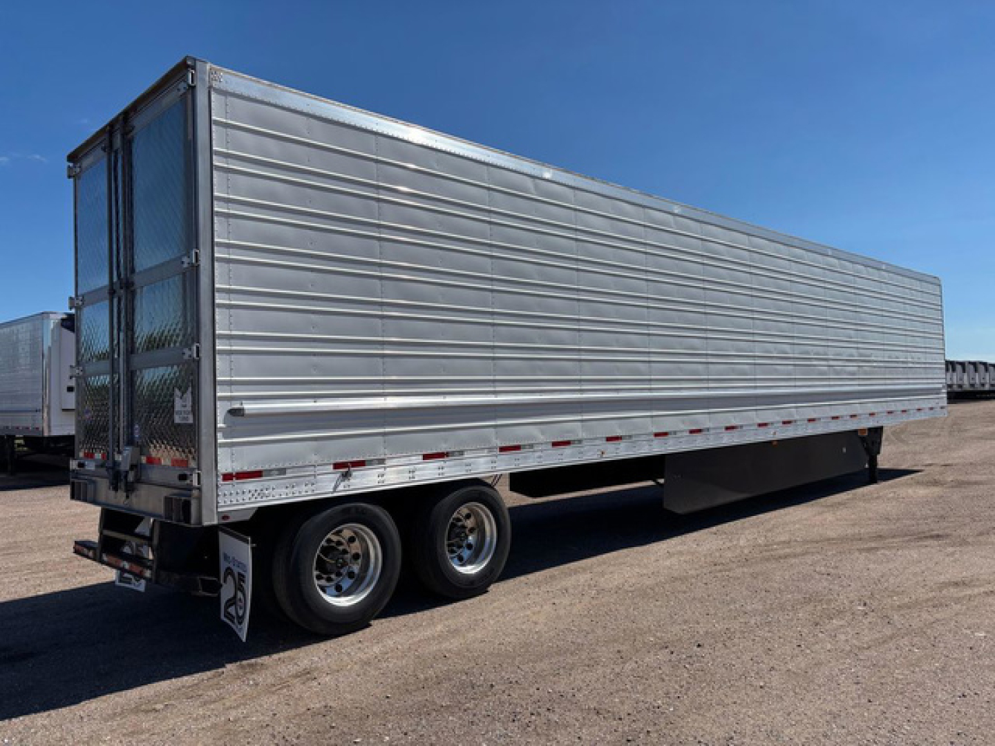 Refrigerated trailer in service showing metal side panels and dual rear doors.