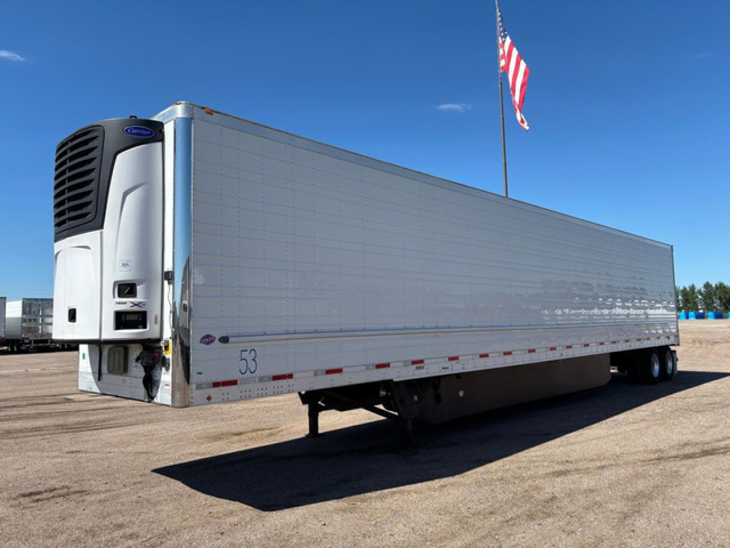 Used 2021 Utility Reefer trailer with white body and blue ramp area, front cooling unit, American flag, visible VIN 1UYVS2533M2382664, stock U91139, number 53 near wheel, side underrun guard.