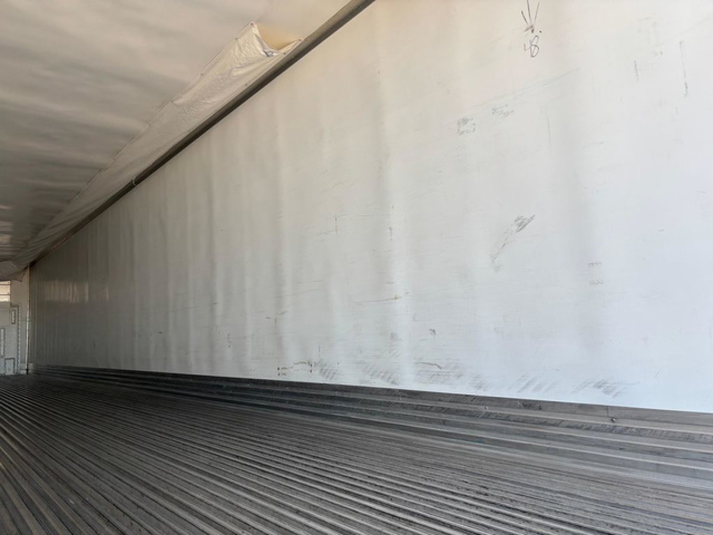 Trailer cargo area side wall and floor showing ribbed floor of a refrigerated trailer (new/used) inside a Utility reefer.