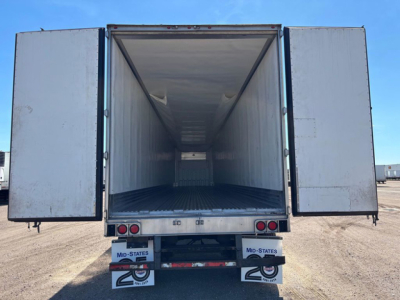Utility reefer trailer with rear doors open showing empty cargo area, interior walls and floor, rear bumper lights and mud flaps.