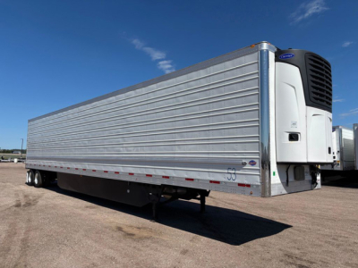 Trailer side view of a 2021 utility reefer with refrigeration unit at front, silver aluminum panel sides, undercarriage and wheels visible, stock number U91139.