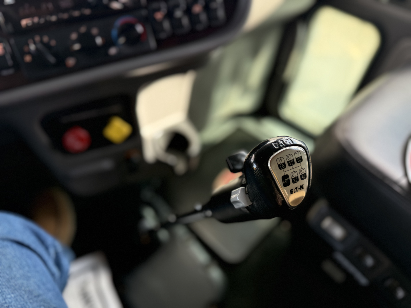 Peterbilt 389 interior view focusing on the automatic shifter with numeric buttons, dashboard controls visible in background.
