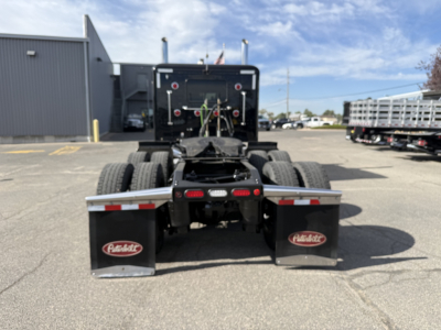 Truck chassis view from rear showing fifth wheel, dual rear axles, and fuel tanks with Hobart logos on mudflaps.