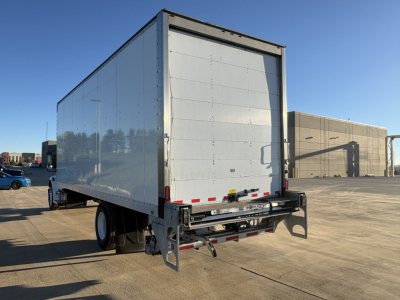 Freightliner M2-106 box truck rear view showing roll-up cargo door and reflective tape