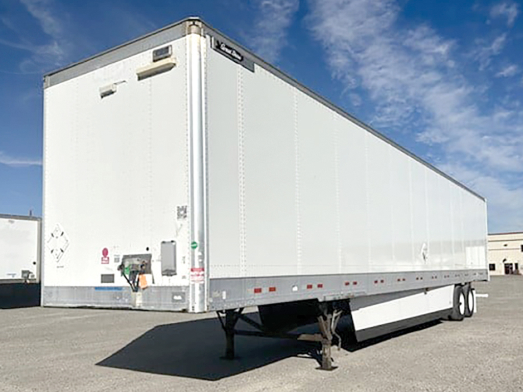 Trailer side and front of a white Great Dane Champion SE semi-trailer with landing gear, side decals, and rear doors visible.