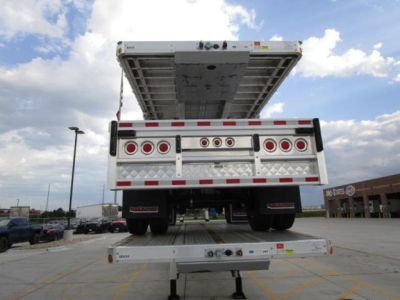 Rear view of a 2027 Reitnouer flatbed trailer with tailgate raised and undercarriage visible, stock N87116, VIN 080434.