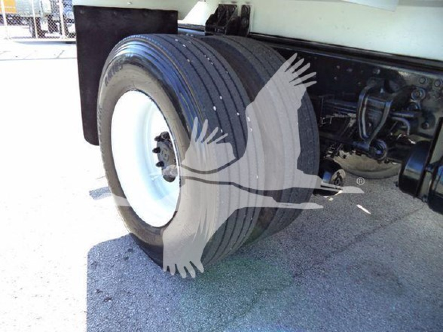 Vehicle wheel and dual rear tires of a 2019 Hino 338 truck showing the rear axle and suspension components.