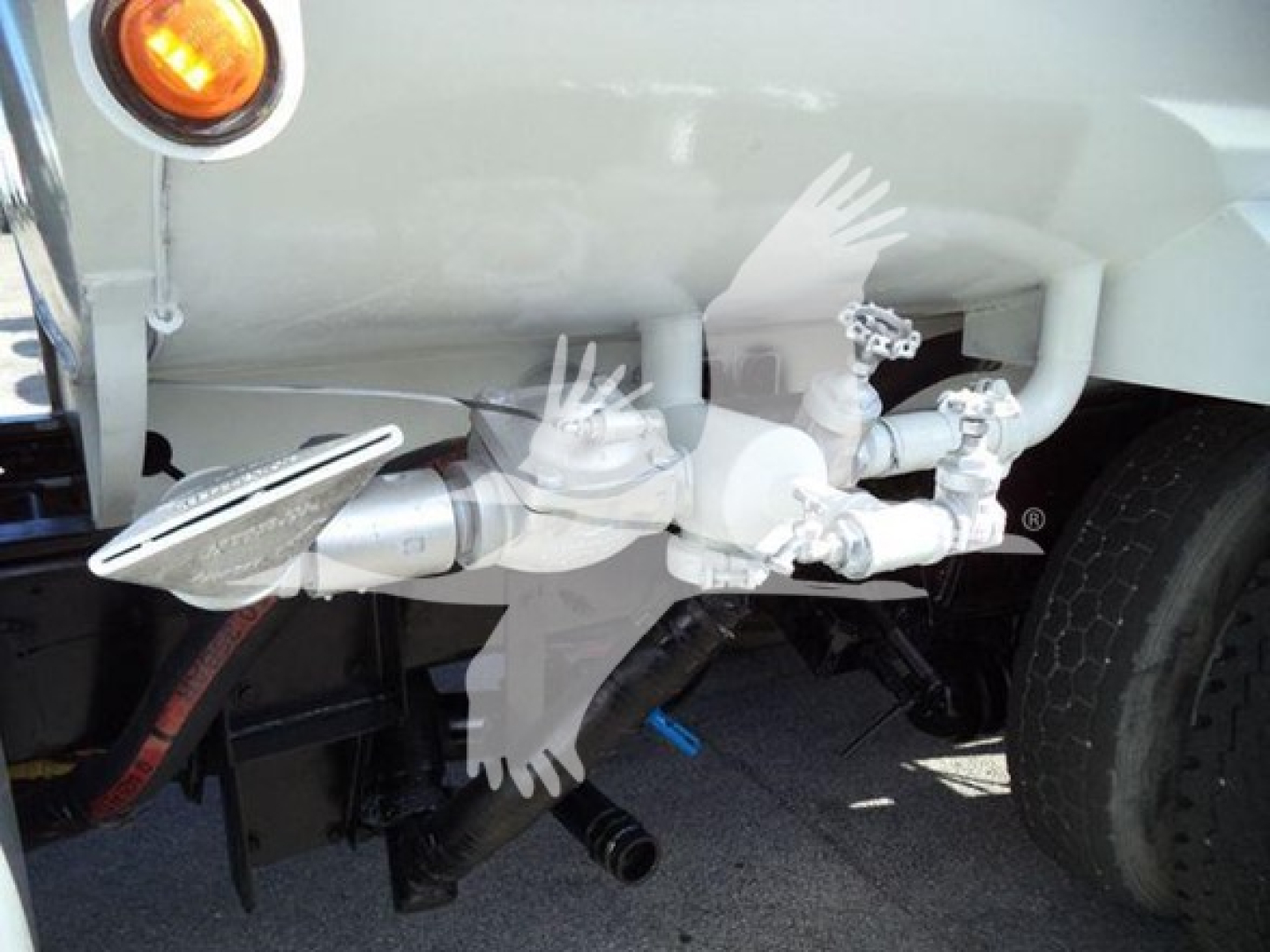 Trucks component view showing rear air tank and plumbing on a 2019 Hino 338 with visible hoses, valves, and piping under the cargo area.