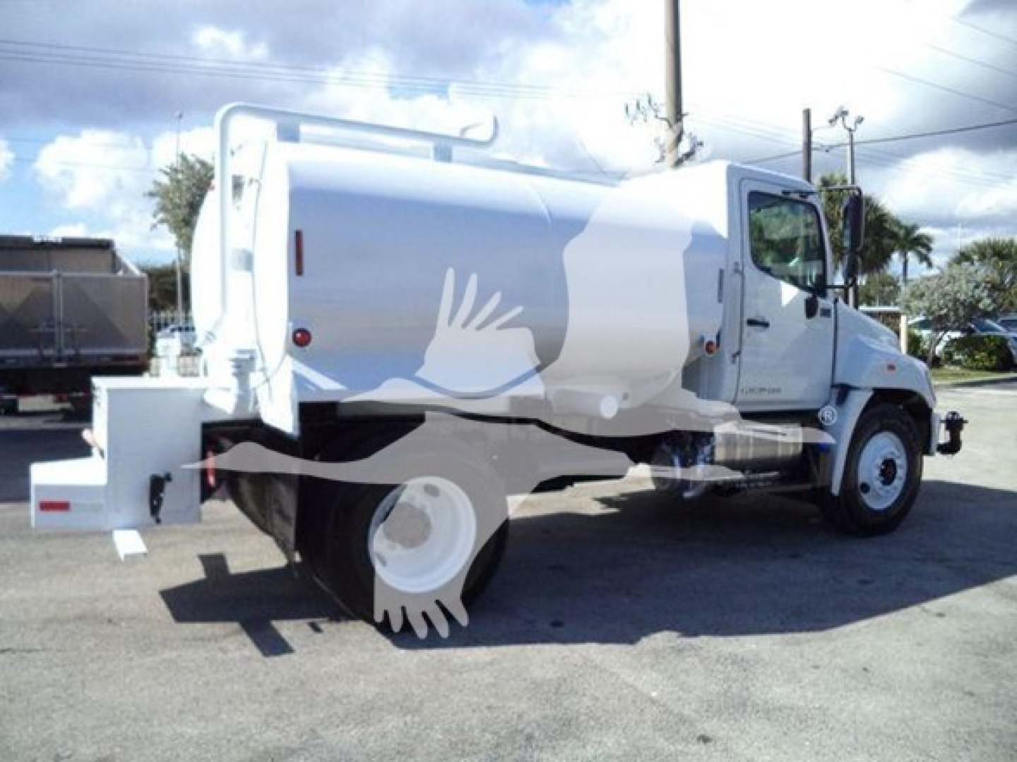 Truck side view showing 2019 Hino 338 fuel/water tanker with cylindrical tank and rear toolbox.
