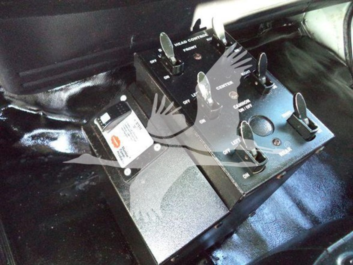 Hino 338 vehicle cockpit area with a control switch panel and circuit breakers mounted under the dashboard.