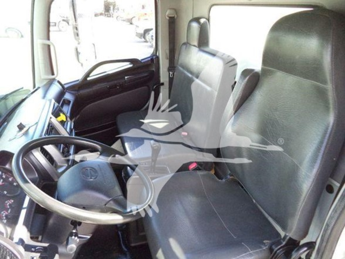 Hino 338 truck interior showing driver's seat and passenger seat with steering wheel and dashboard