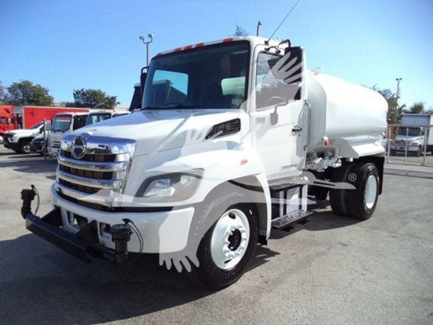 White 2019 Hino 338 medium-duty truck with a large cylindrical tank mounted on back, front view showing bumper and chrome grille.