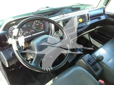 Dashboard and steering wheel of a 2019 Hino 338 truck interior with black/gray seating and center console.