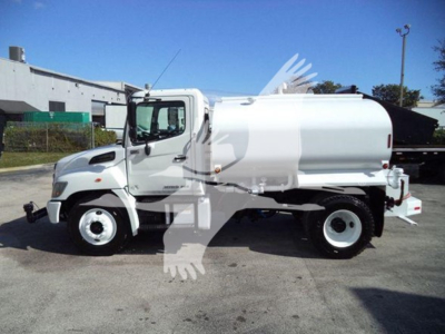 2019 Hino 338 vacuum/cleaning or water tanker truck side view with white cab and tank, no visible text on body