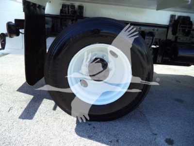 Wheel and tire assembly of a 2019 Hino 338 chassis showing white wheel hub and spare rim mounted under truck.