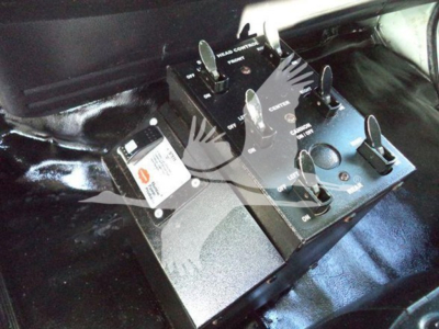 Hino 338 vehicle cockpit area with a control switch panel and circuit breakers mounted under the dashboard.