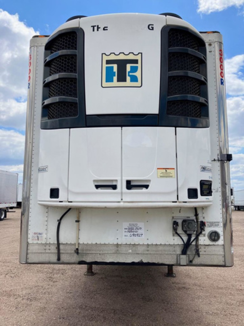 Trailer refrigeration unit back view showing cold air condenser, vertical cooling vents, and TS logo on unit doors.