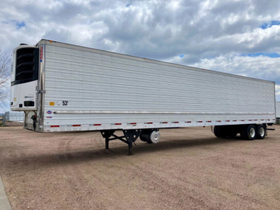 Utility reefer trailer in side view showing aluminum riveted refrigerated box with tail lights, landing gear, and refrigeration unit at front left; 53' length.