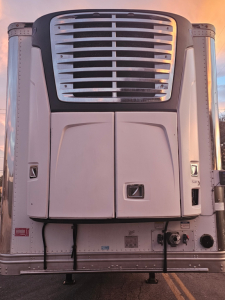 Trailer front view showing Hyundai ThermoTech TL reefer unit with grille and vertical doors, no visible text legible.