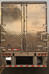 Back view of a Hyundai ThermoTech TL reefer trailer showing diamond plate metal doors and rear hardware.