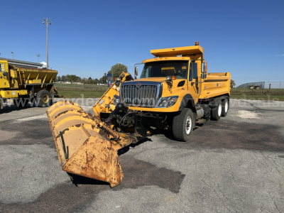 2016 International WorkStar 7600 snow plow truck with front-mounted bucket and rear dump bed, yellow paint, VIN 3HTGSSNT7GN292791, plow attachment in front