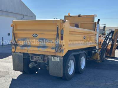 Dump truck bed and rear side of a 2016 International WorkStar 7600 plow truck showing yellow dump bed and dual rear wheels.